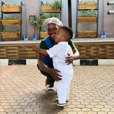 Nanaville caretaker delicately and lovingly handles a toddler