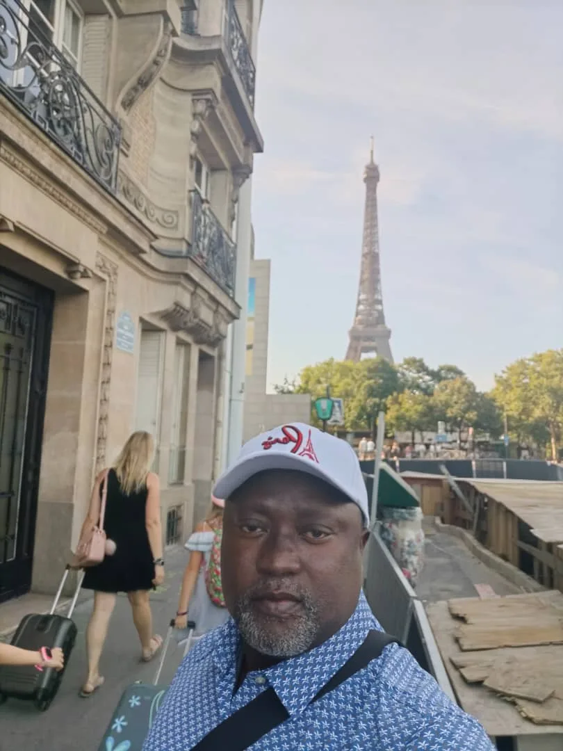 joseph-mbazzi-muguluma-in-paris-eiffel-tower-in-background