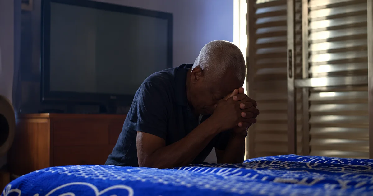 Contemplative Man in a Dim Bedroom.png
