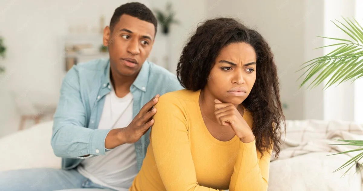 sad-husband-calms-offended-upset-millennial-african-american-wife-ignore-guy-after-quarrel-living-room