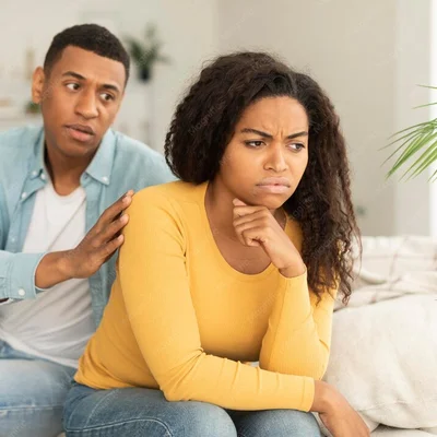 sad-husband-calms-offended-upset-millennial-african-american-wife-ignore-guy-after-quarrel-living-room
